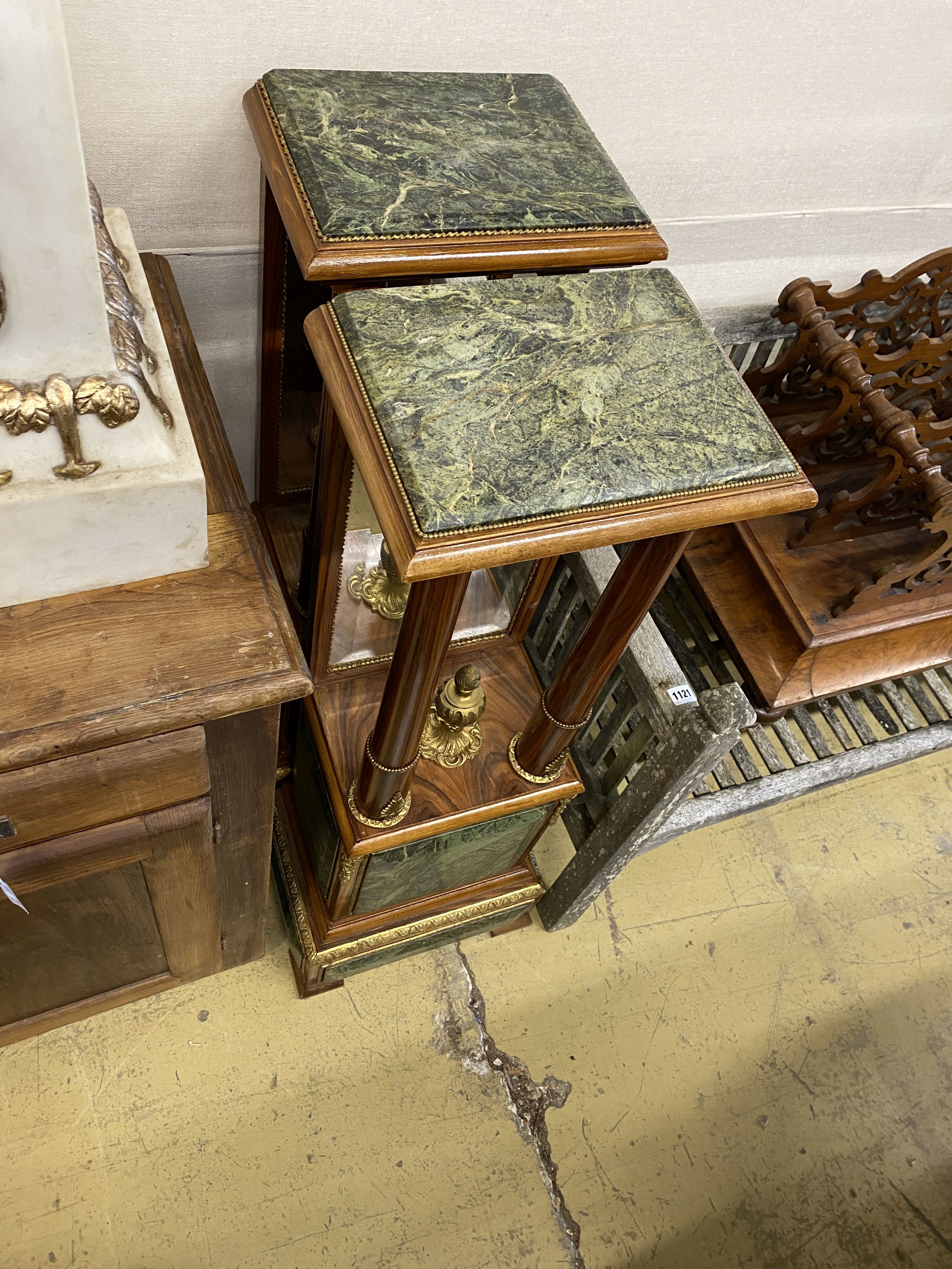 A pair of Empire style gilt metal mounted walnut mirrored pier tables, width 34cm, depth 24cm, height 109cm